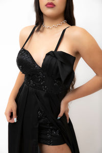 Black embellished dress closeup.