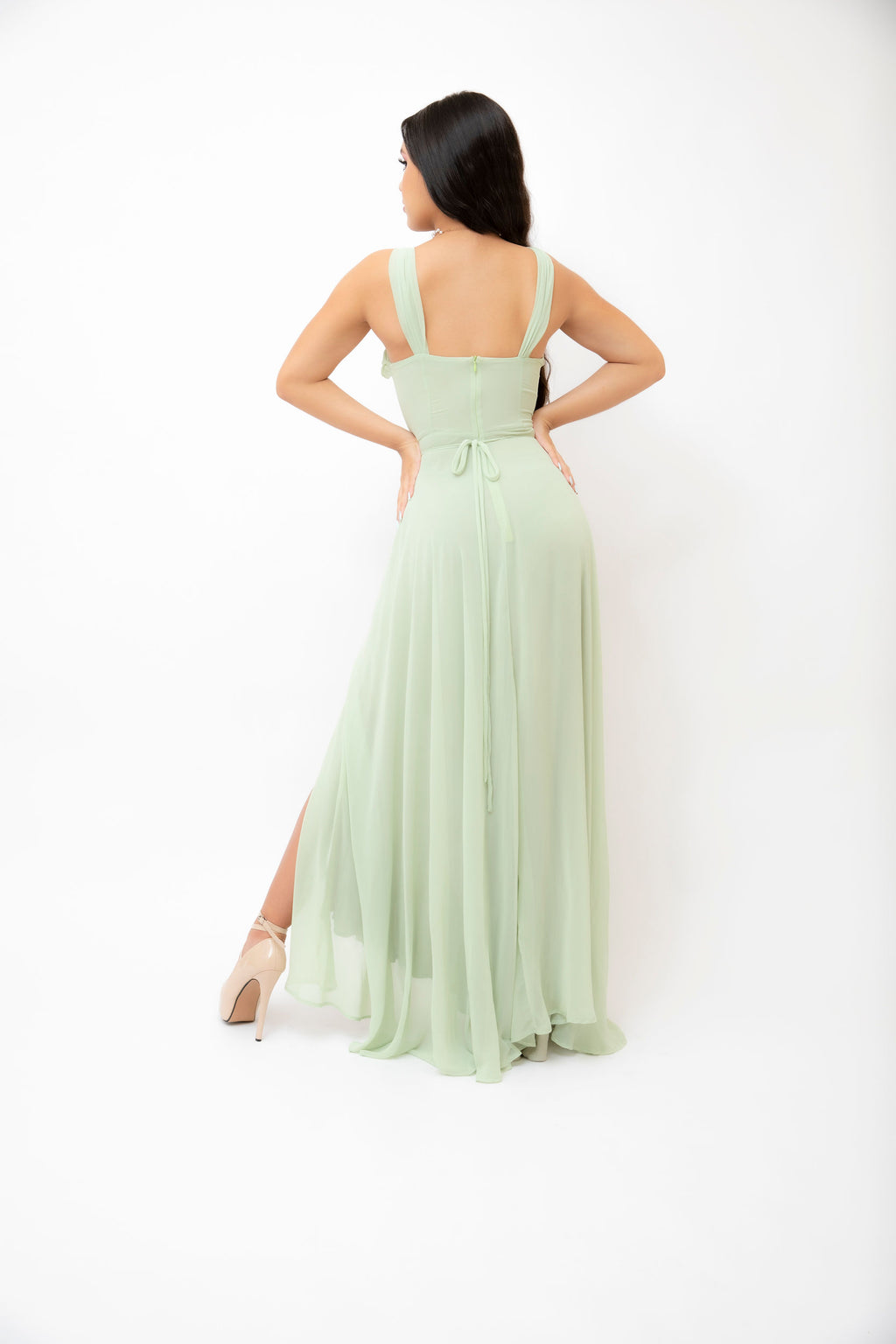 Green draped gown back view.